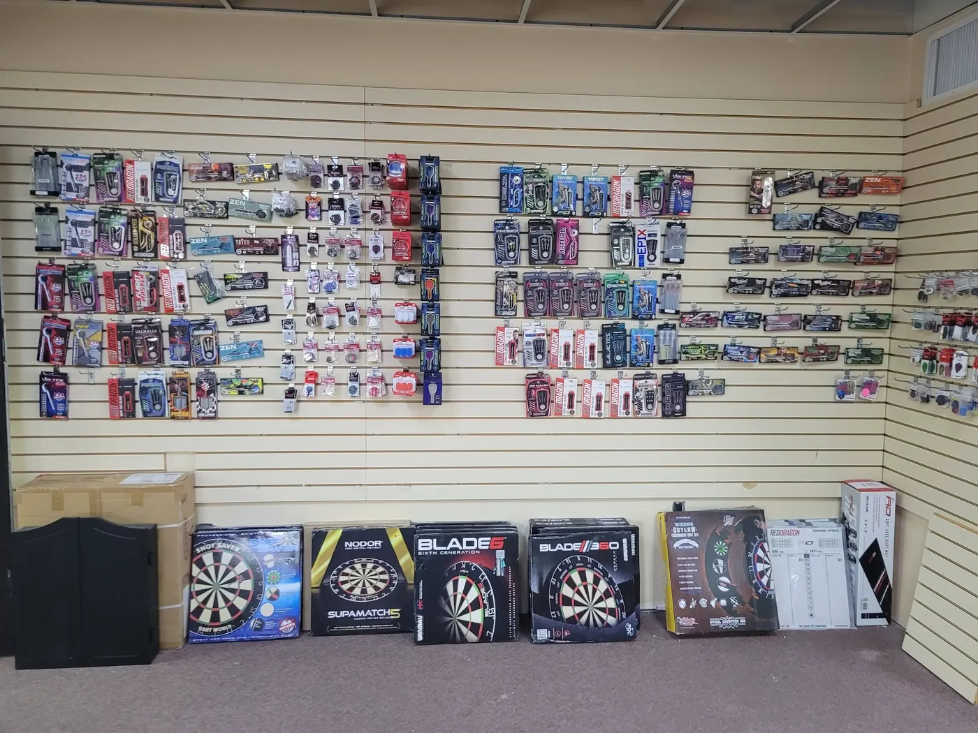 Wall of dartboards and darts at the LEMCO store