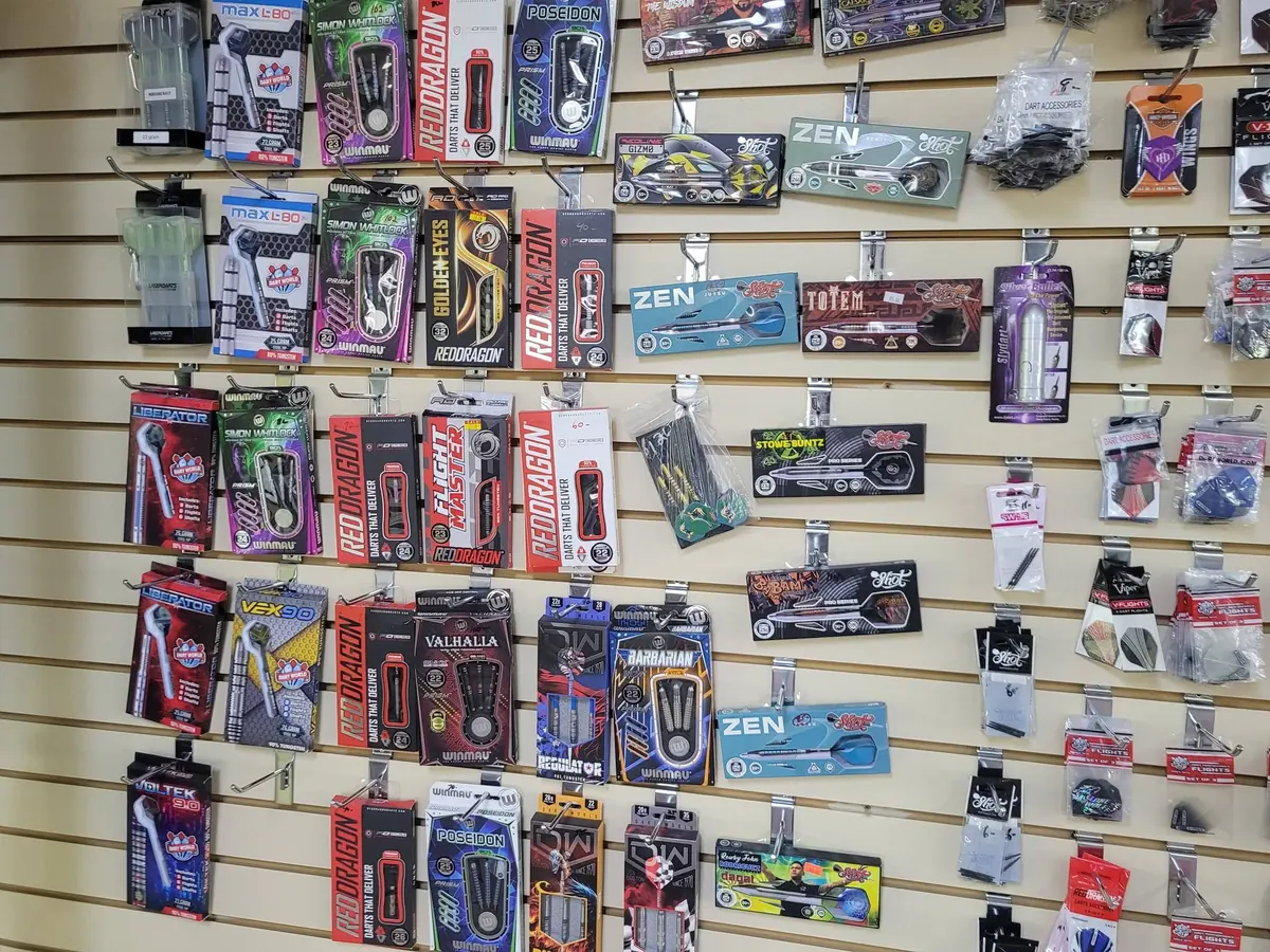 Packs of darts hung on the dart wall